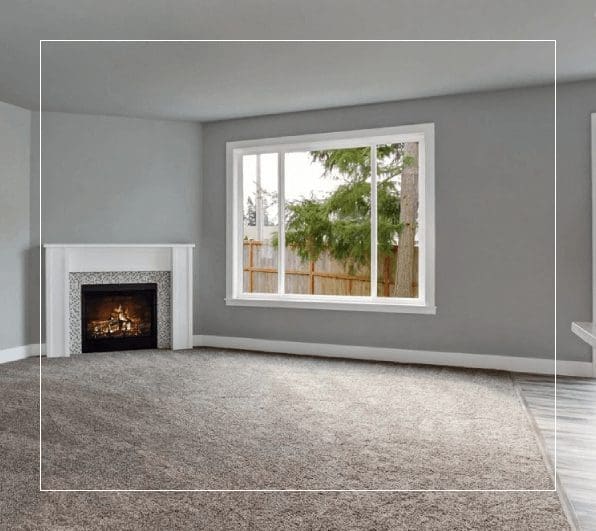 A living room with a fireplace and large window.