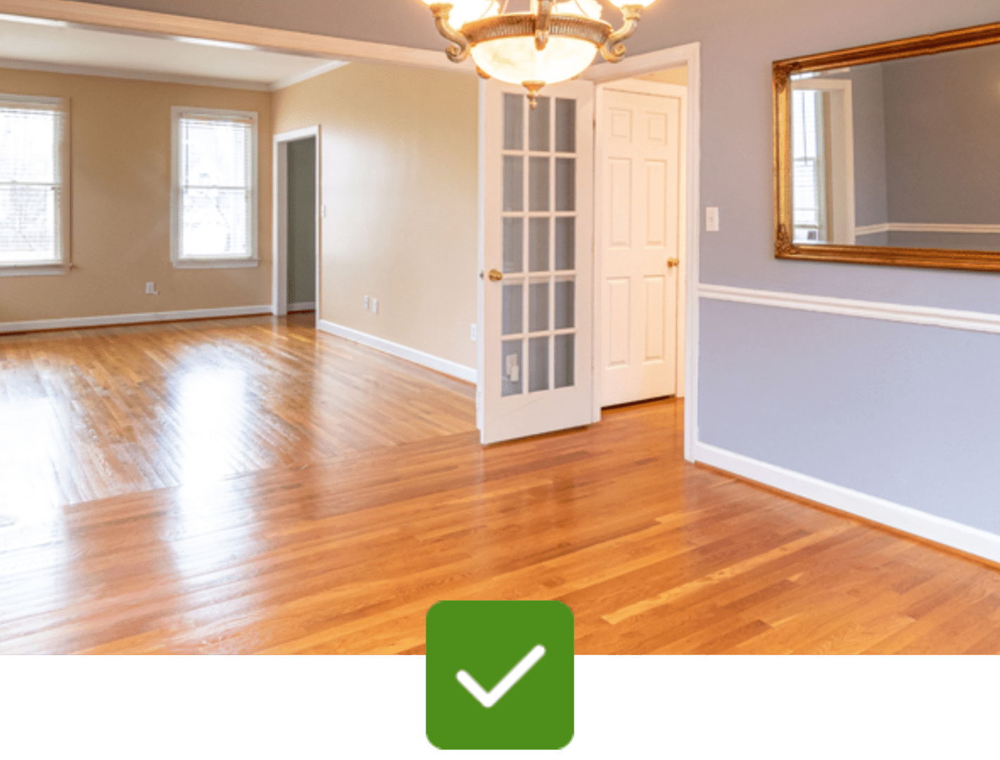 A room with hard wood floors and a door open.