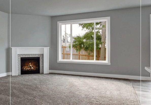 A living room with a fireplace and large window.